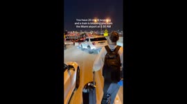 Hundreds of travelers climb a stalled train to catch their flight in Miami