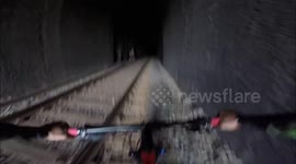 Cyclists Narrowly Avoid Oncoming Train