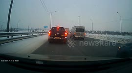 Jackknifing Truck Slides Through Traffic on Icy Road