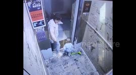 Woman uses toy shovel to block elevator doors which causes malfunction that traps her child