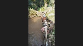 Girl's skirt get stuck on post as she tries to jump into pond