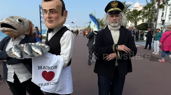 Macron Loves Trawling  Ocean Rebellion stages 'Macron Loves Trawling' protest in Nice  Activists from Ocean Rebellion stage a street theatre protest in Nice. The performance features a performer in a caricature mask of President Emmanuel Macron, depicted