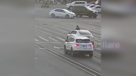 China: Motorcyclist Flies Over Car And Crashes Through Rear Windshield After Violent Collision - Buy, Sell or Upload Video Content with Newsflare