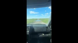 Car gets stuck in large puddle and towed out in Manitoba, Canada