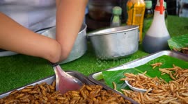Disabled woman without hands cooks street food to sell to tourists in Thailand