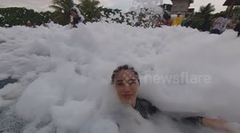 Oddly terrifying moment reveller is engulfed by foam at pool party