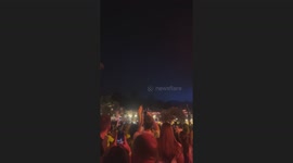 Partygoers watch missiles fly overhead during beach party in Batroun, Lebanon