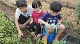 Kids gardening and planting in the farm
