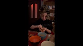 Cat climbs on owner's head to supervise 'meatball making.'