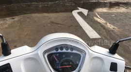 Rain-soaked Saigon street captures moody reflections and calm atmosphere after passing rain shower