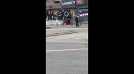 Man clings to woman’s legs in funny street scene in Bogotá, Colombia