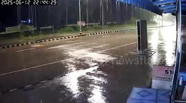 Strong wind topples signboard onto road in Sakon Nakhon, Thailand