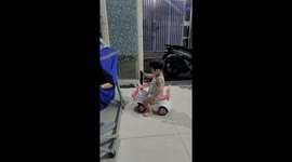 The 18-month-old baby skillfully balances and operates the TV like a true professional