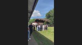 Students help carry bamboo hut before it breaks when a youngster does a pull-up