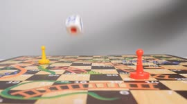 Slow motion video of a hand rolling a dice on a board game. Board game with friends concept