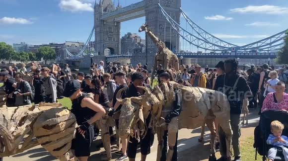 Herds of animal puppets pass near Tower Bridge in London
