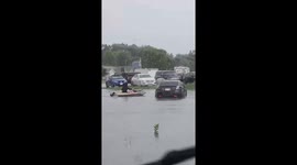 Man in Kayak Assists Driver During Holmen, Wisconsin Street Flooding