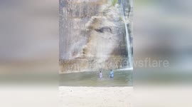 Boulders crash into lake narrowly missing swimmers