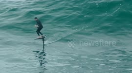 UK weather, heat warning, humid cloud and sunshine, E-foiling at Cribber Point. Newquay Cornwall, UK