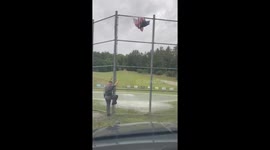 Trooper Climbs Fence to Fix American Flag in Silence