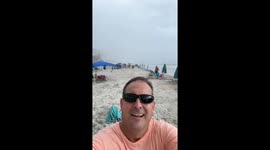 ‘Woohoo!’ in the wind: Man turns rainy beach day into pure joy in Daytona Beach