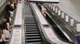 An escalator in Hyde Park Station that is decorated in Pride colours