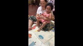 Baby's mood quickly changes after a fake spider pops out of what seemed like a sweet present