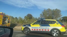 A large white semi-trailer truck is seen immobilized on the shoulder