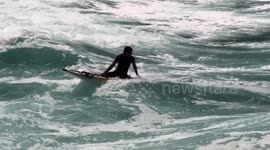 UK Weather, Cooler spell breaks, Lifeguard practises on his rescue surf ski, Great Western Beach, Cornwall, UK