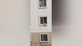 A 4-year-old girl is hanging down from the third floor window. People of the society raised an alarm after seeing the girl in Pune, Maharashtra