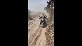 Stuck Motorcycle Kicks Up Dust