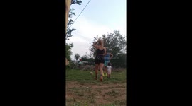 Family workout interrupted by curious cat in Ypané, Paraguay