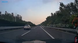 White vehicle collides with overturned van on highway in Shanghai, China