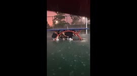Students Seek Shelter Under Table Tennis Table