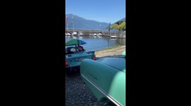 Several Amphicars sail into lake after street drive in Luino, Italy