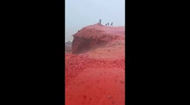 Red rainwater flows down cliffs on Hormuz Island, Iran