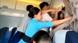 Cabin crew wrestle with crazed fans trying to reach Chinese actor in business class