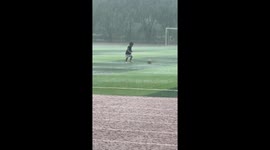 Boy Plays Soccer in the Rain