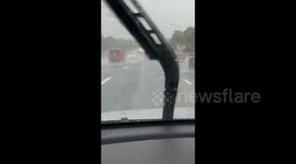 US: Drivers Navigate Roads During Heavy Rainfall in Jericho