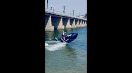 Man Nearly Falls into Water on Motorboat