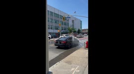 Malfunctioning fire hydrant used as free car wash by passing vehicles