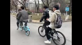 Four Boys Ride Two Bicycles Awkwardly