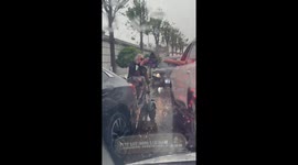 Driver Helps Soaked Elderly Man with Umbrella