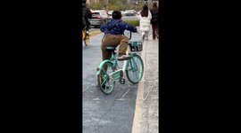 Boy Struggles to Ride Bike