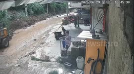 Family escapes massive landslide at last second as it crushes digger against their home
