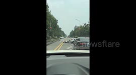 Sudden road collapse sends car plunging into water-filled sinkhole in China