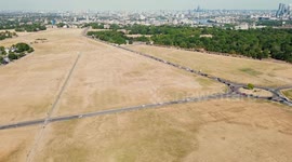 Dry brown grass covers Blackheath Common during heatwave in London