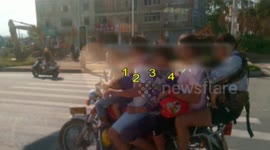 Seven people manage to squeeze on the back of a motorbike
