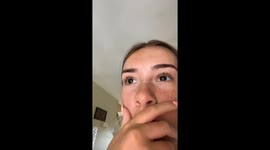 Girl about to sunbathe spots black bear in garden rummaging through trash