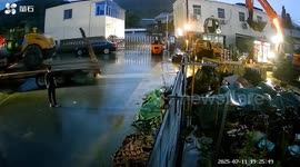 Excavator 'catches' road roller that slid off back of truck in China